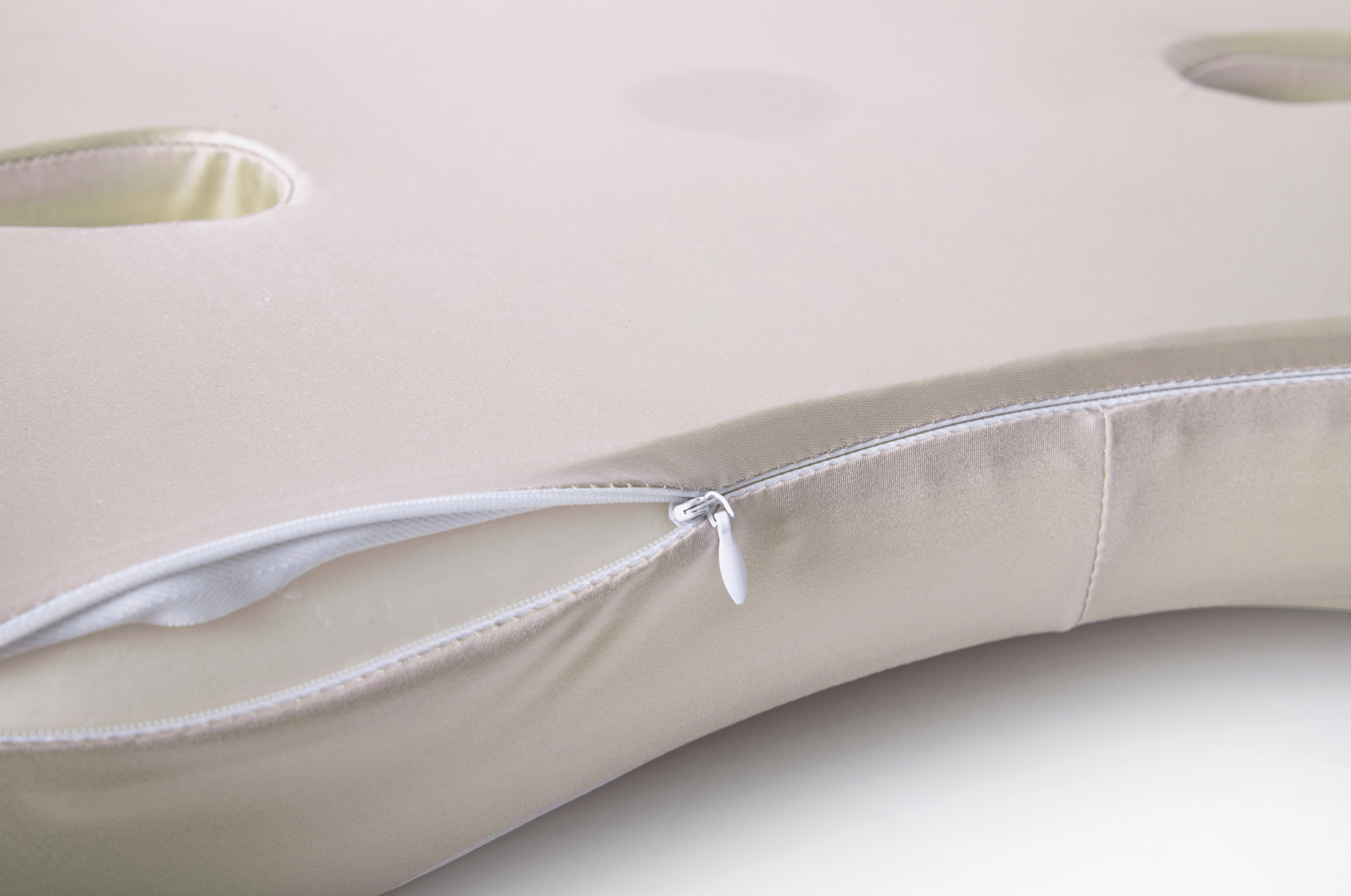 Beige body pillow with zipper on a light background